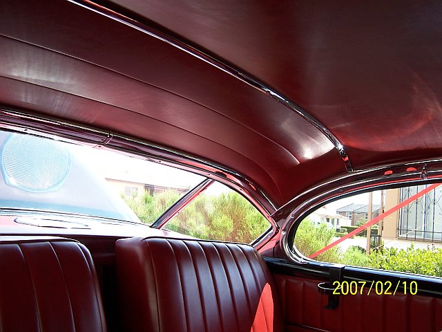Inside a 1950 Cadillac with a red interior