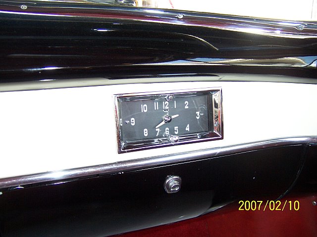 Picture of a clock on a passenger side dashboard of a 1950 Cadillac