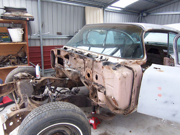 1959 Cadillac on jack stands waiting for the frame to be removed for restoration.