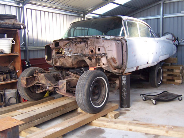 Metal stands in place as the Cadillac frame is removed from the body.