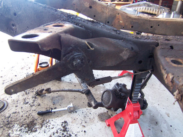 Stripping the parts off the Cadillac frame before sending it out.