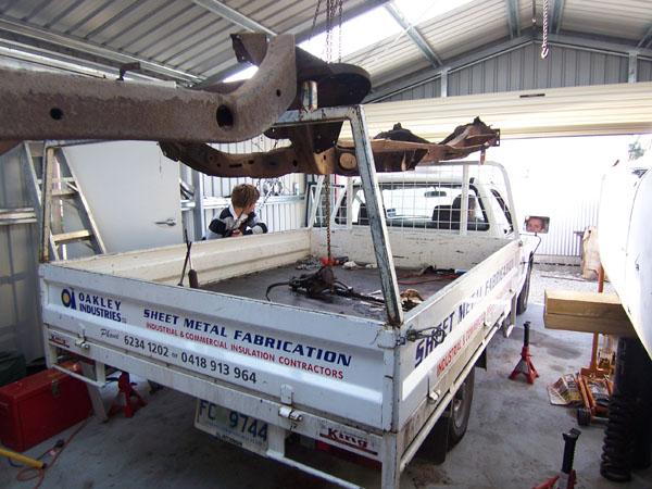 Cadillac frame on top of pickup truck on its way to restoration.
