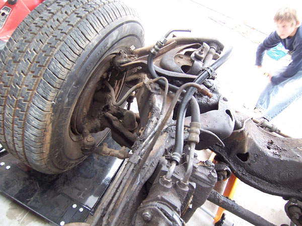 Removing steering and other parts of the Cadillac frame.