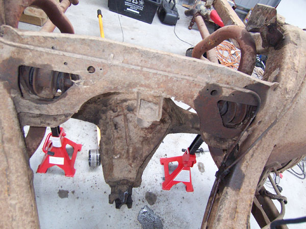 Rear end of the Cadillac frame on jack stands.