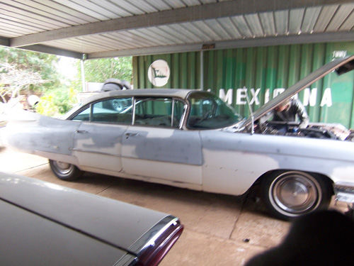 Passenger side of a 1959 cadillac in gray before primer