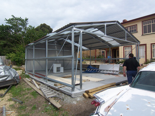 Putting metal roof on a garage.