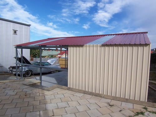 Putting up the sheet metal on the garage that will house the 1959 Cadillac