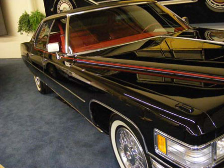 passenger side view of a 1976 black cadillac