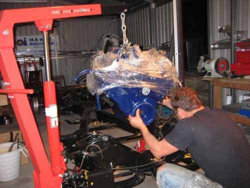 Lowering the motor on to the 1959 Cadillac frame.