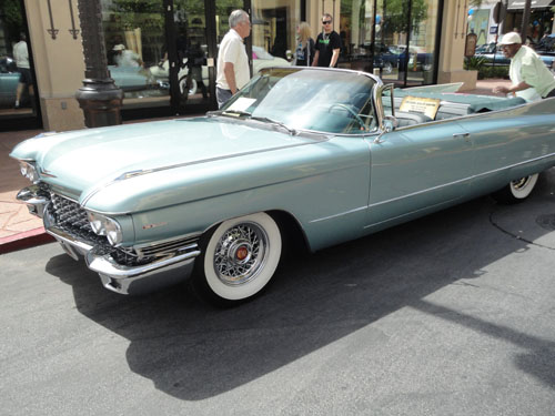 Teal colored cadillac convertible