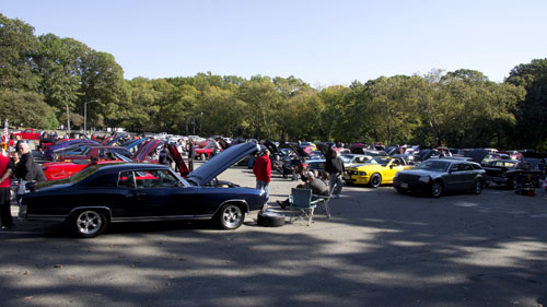 classic car owners sitting at a car show.