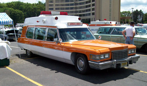 orange and white Cadillac ambulance