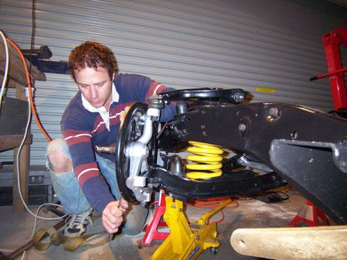 Paul installing his shocks on his Cadillac.