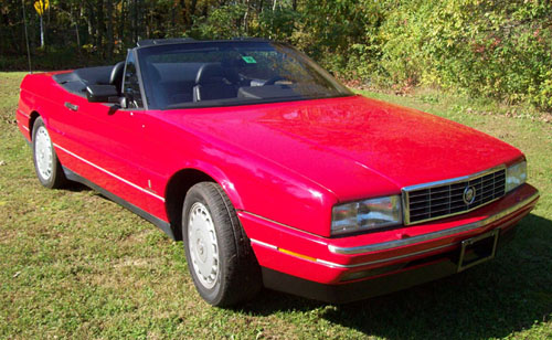 front passenger side picture of a red Cadillac Allante