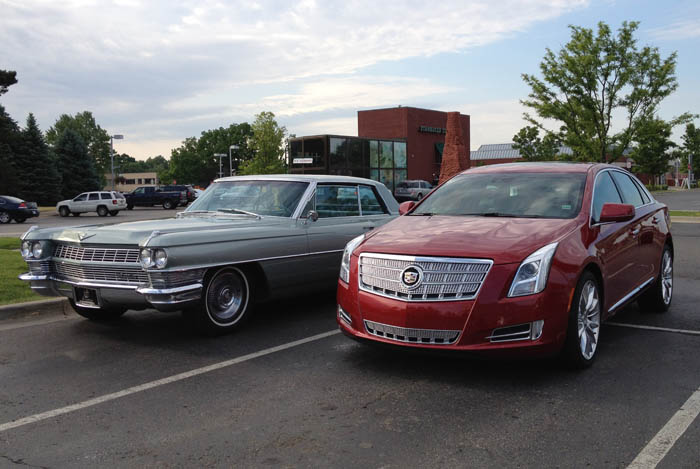 Cadillac Deville next to a Cadillac XTS