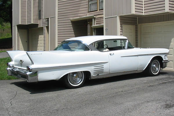 White 1958 Cadillac in driveway