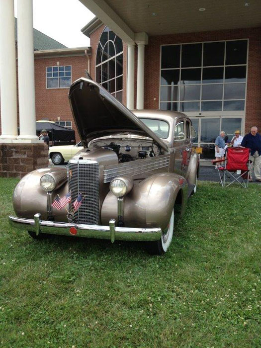 Silver 1930s Cadillac with hood open