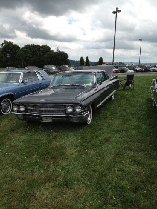 black cadillac on grass