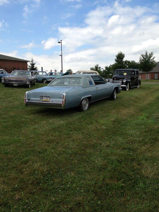 back of blue cadillac