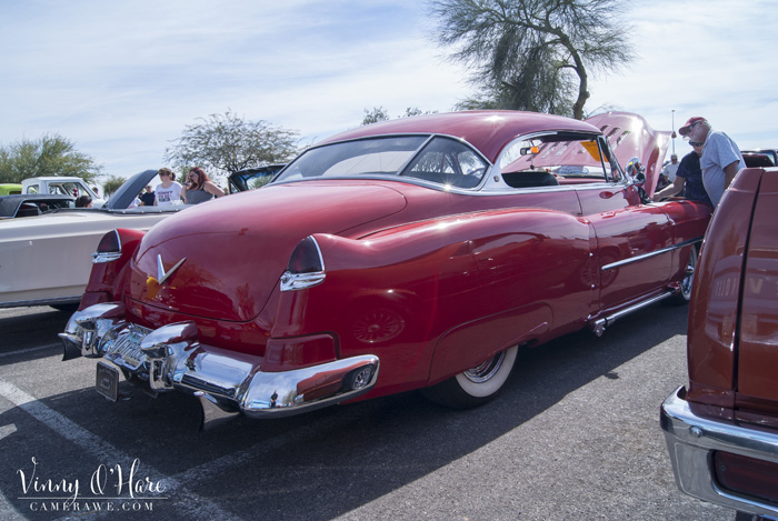 people looking at Cadillac engine
