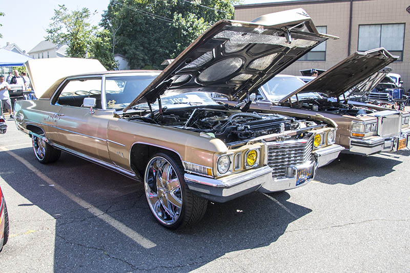 funky cadillac with hood open